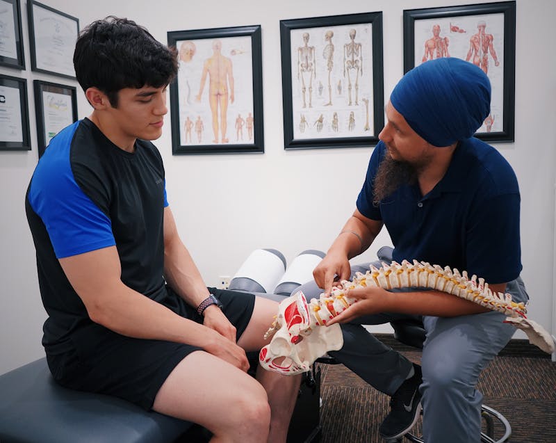 a chiropractor explaining something to a patient